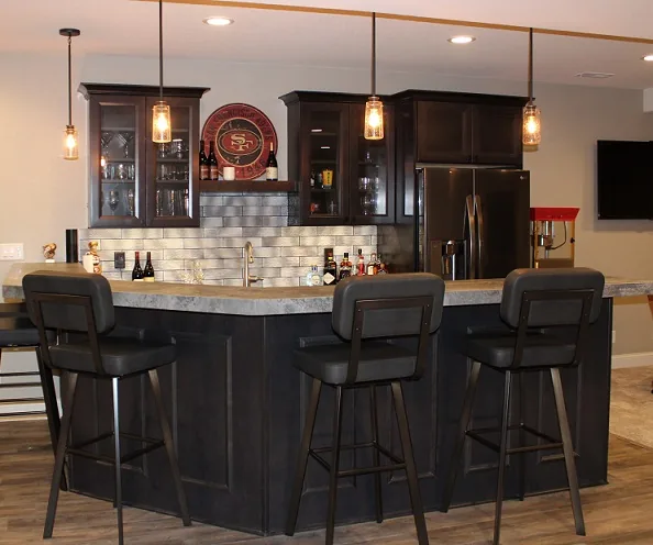 Sussex Basement Remodel with a bar by Reality Construction